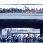 Thousands block major LA freeway, spray graffiti to protest Donald Trump's immigration crackdown