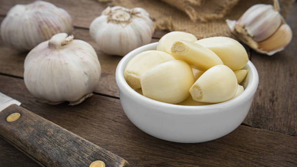 Why should one eat 2 cloves of raw garlic daily?