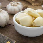 Why should one eat 2 cloves of raw garlic daily?